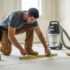 Contractor inspecting subfloor after dustless tile removal, highlighting the importance of preparation for new flooring